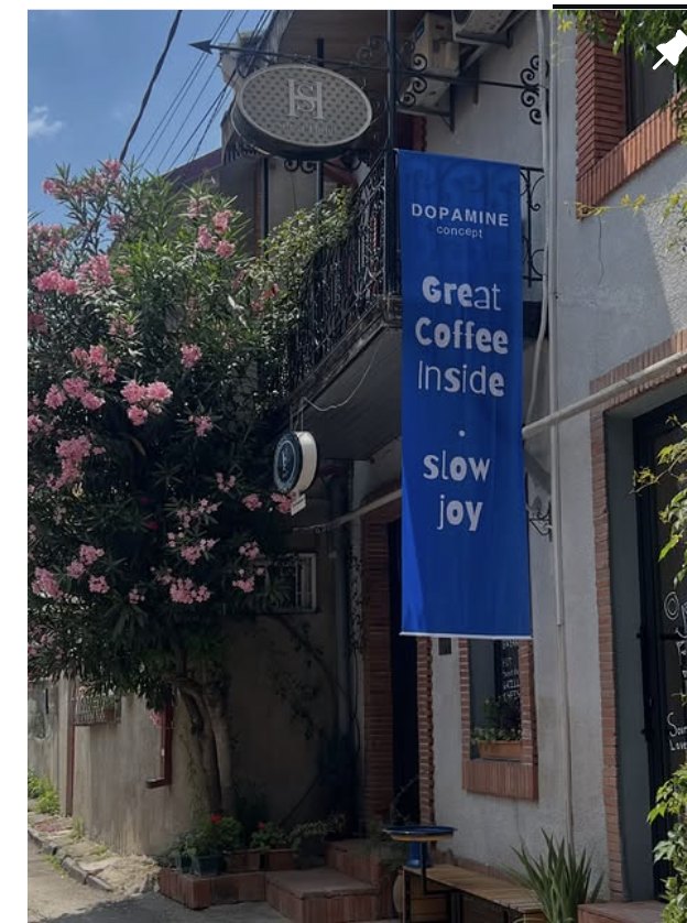 The Dopamine Concept storefront with its blue 'Great Coffee Inside · slow joy' banner in Old Tbilisi